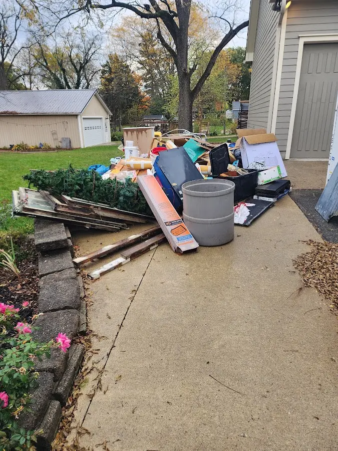 Dumpster being loaded with debris for Roofing Dumpster Rental in Deer Park